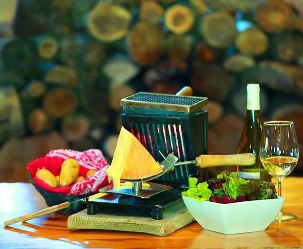 Raclette cheese scraped over potatoes